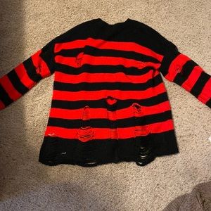 Black and red torn sweater